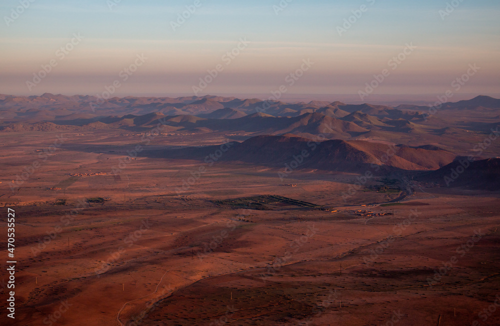 The view from a hot air balloon down to the desert and villages near Marrakech, sunrise in April, Morocco