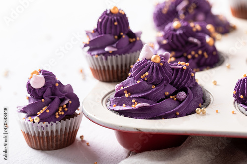 Delicious cupcakes with violet cream ready to eat. photo