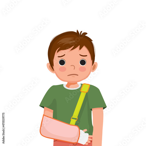 Little boy with broken arm in bandage wearing arm sling after accident.