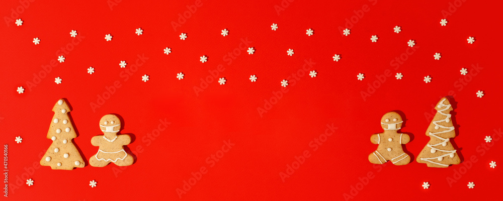 Happy New Year's 2022 set of gingerbread man in face mask from ginger biscuits glazed sugar icing decoration on classic traditional red background, minimal seasonal pandemic winter holiday banner Happy New Year's 2022 set of gingerbread man in face mask from ginger biscuits glazed sugar icing decoration on classic traditional red background, minimal seasonal pandemic winter holiday banner