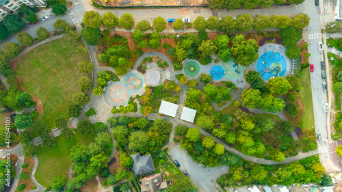 Fototapeta Naklejka Na Ścianę i Meble -  a stunning aerial shot of the park with lush green and autumn colored trees all over the park at Historic Fourth Ward Park in Atlanta Georgia USA