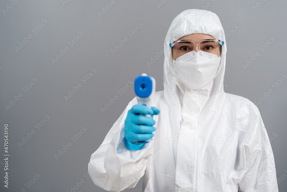 doctor in protective PPE suit scanning with infrared thermometer doctor in protective PPE suit scanning with infrared thermometer