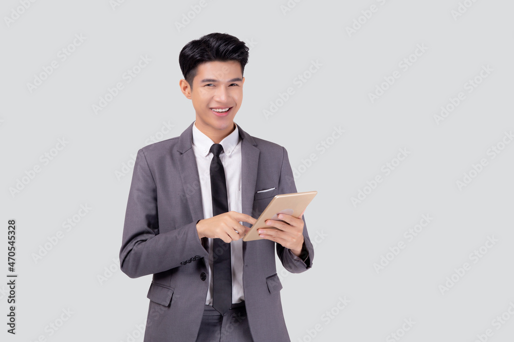 Portrait young asian business man in suit standing using tablet computer to internet isolated on white background, businessman confident touch screen digital pad with success, communication concept. Portrait young asian business man in suit standing using tablet computer to internet isolated on white background, businessman confident touch screen digital pad with success, communication concept.