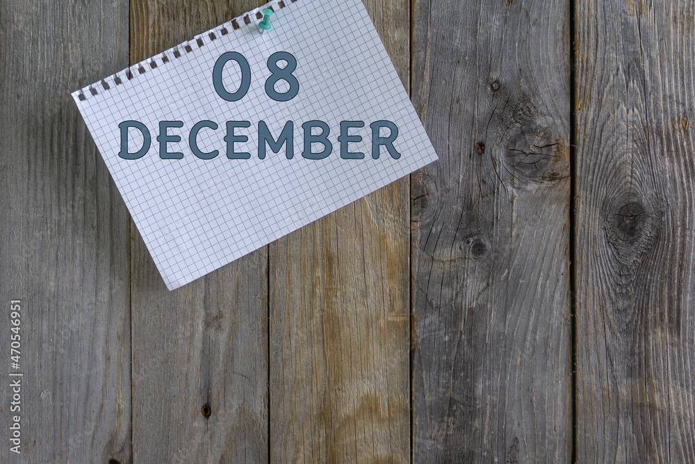 Day of month.A white sheet of checkered paper from a notebook with a date is pinned with a stationery button to a wooden background. Day of month.A white sheet of checkered paper from a notebook with a date is pinned with a stationery button to a wooden background.