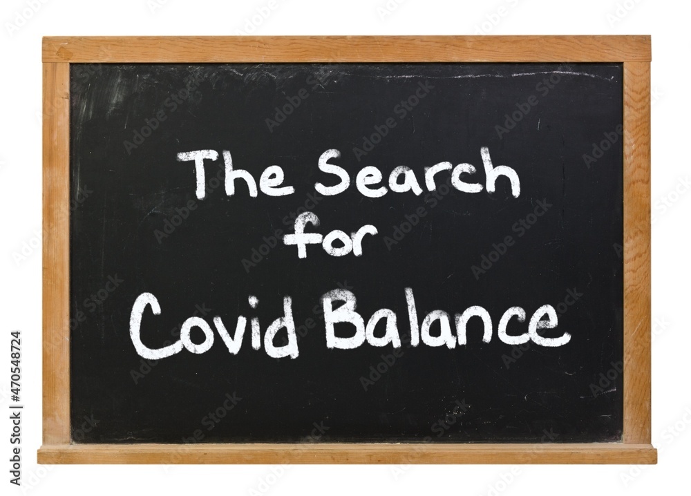 The Search for Covid Balance written in white chalk on a black chalkboard isolated on white The Search for Covid Balance written in white chalk on a black chalkboard isolated on white