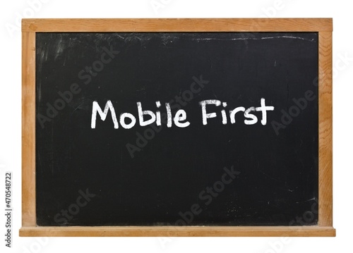 Mobile First written in white chalk on a black chalkboard isolated on white