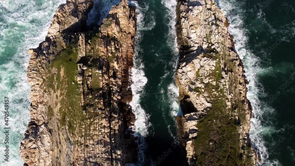Waves crash around two rocky cliffs that reach into the Atlantic Ocean. Cinematic style edit. Shot in 4k. Waves crash around two rocky cliffs that reach into the Atlantic Ocean. Cinematic style edit. Shot in 4k.