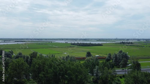 Aerial reveal shot of traffic, fields and Kagerplassen in South Holland, the Netherlands photo