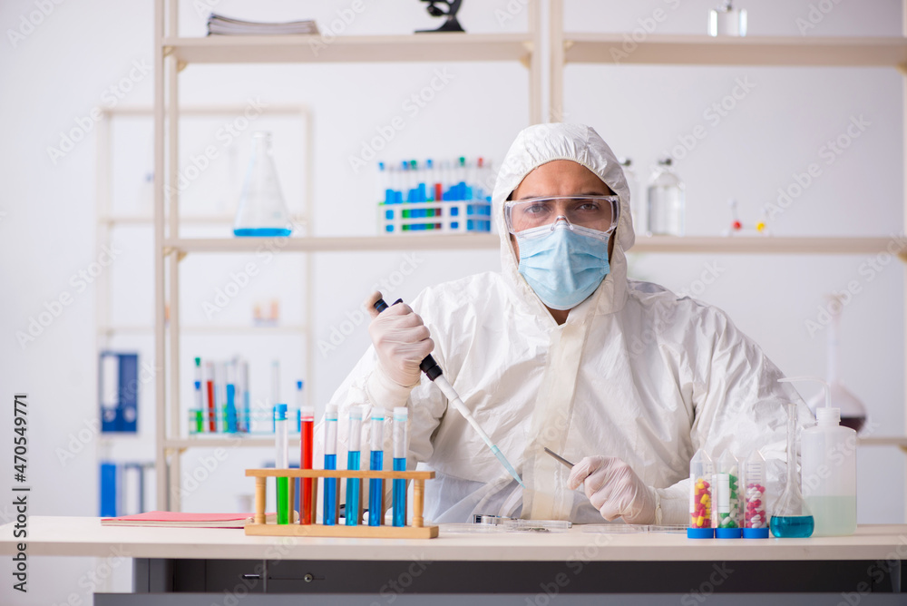 Young male chemist working at the lab during pandemic Young male chemist working at the lab during pandemic
