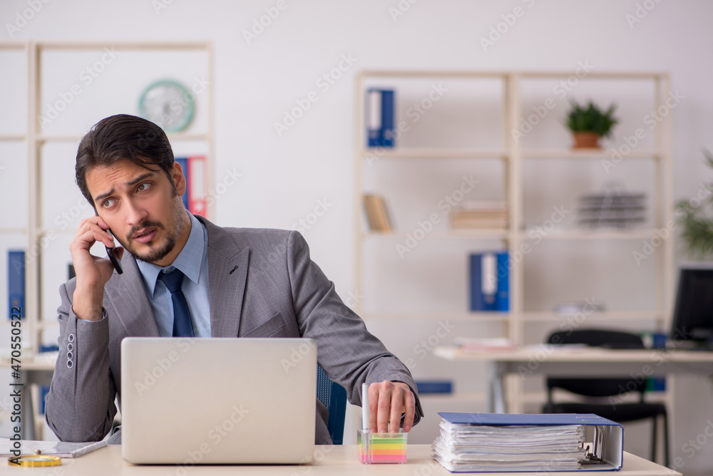 Young male employee working in the office Young male employee working in the office