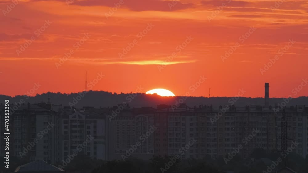 Colorful evening landscape with soft pastel coloured cloudscape over dark distant cityscape with watercolor tinted sunset sky. Abstract nature background Colorful evening landscape with soft pastel coloured cloudscape over dark distant cityscape with watercolor tinted sunset sky. Abstract nature background