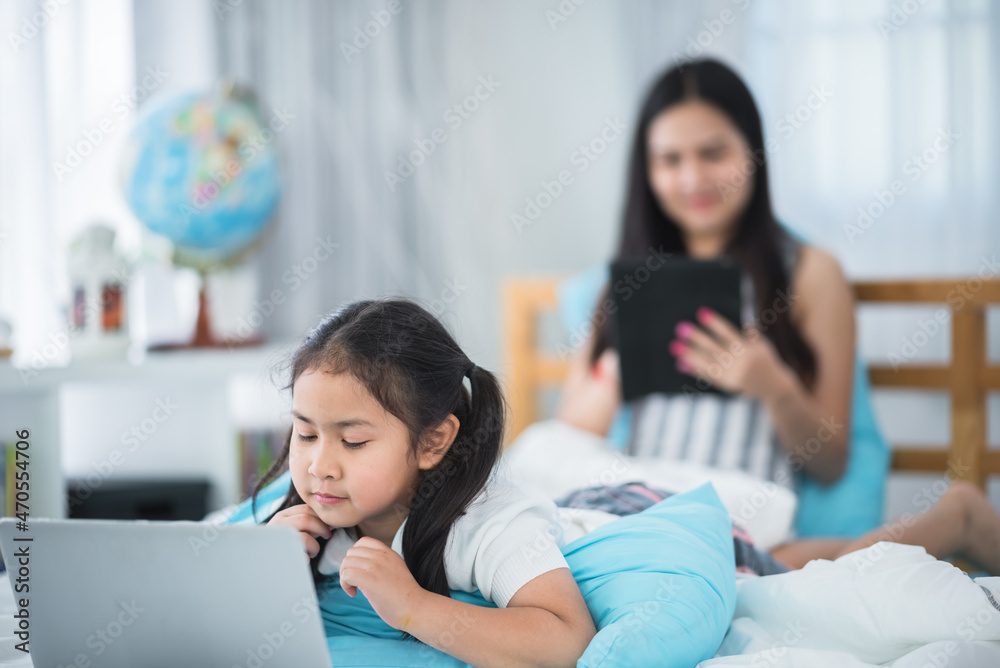 Fototapeta premium mother teaching child girl for doing homework at home, family education activity concept