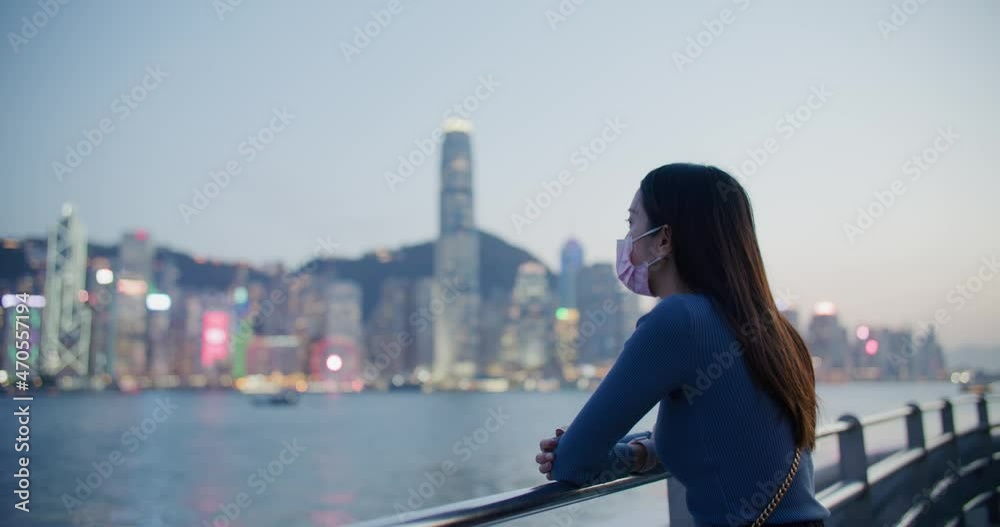 Woman look at the Hong Kong city night view Woman look at the Hong Kong city night view