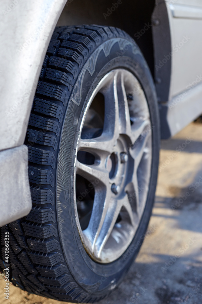 Silver car and wheel with winter rubber studded Silver car and wheel with winter rubber studded