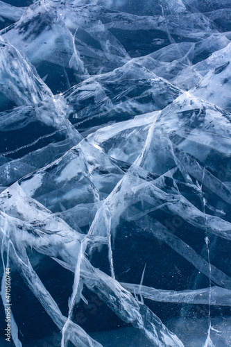 Natural ice with cracks. Blue thick ice with white cracks. Vertical. © Vladimir Kazakov