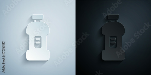 Paper cut Plastic bottle for laundry detergent, bleach, dishwashing liquid or another cleaning agent icon isolated on grey and black background. Paper art style. Vector