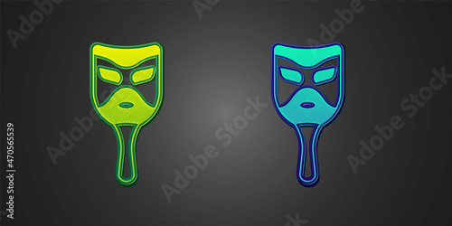Green and blue Carnival mask icon isolated on black background. Masquerade party mask. Vector
