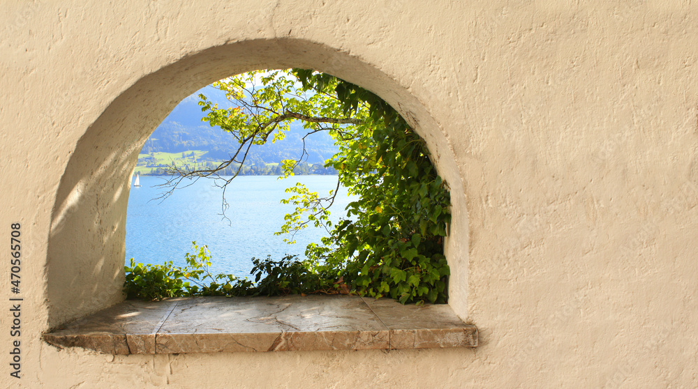 View of Wolfgangsee lake through the window in the medieval fortress wall, Austria