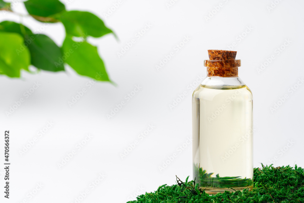 Cosmetics in a bottle, essential oil on moss - obrazy, fototapety, plakaty 