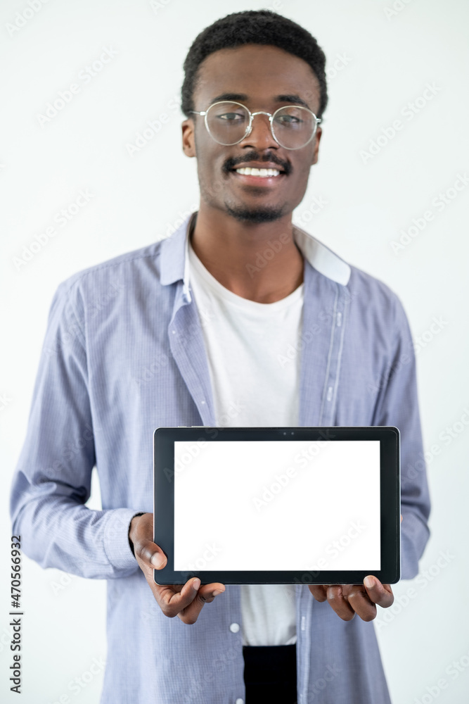 Blank screen. Happy man. Digital technology. Casual smiling guy holding tablet computer isolated white.