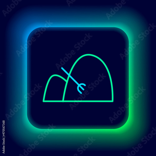 Glowing neon line Bale of hay and rake icon isolated on black background. Colorful outline concept. Vector