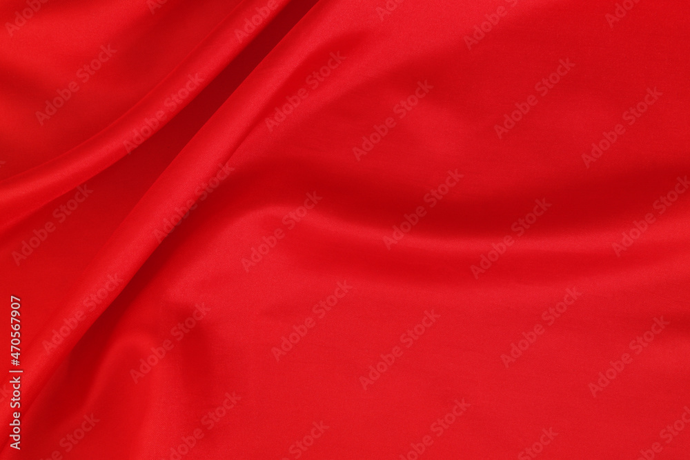 Red satin or silk fabric backdrop. Beautiful wallpaper, wedding background or design element. Room for text.
