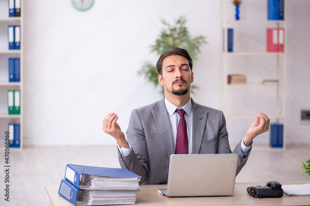 Young male employee working in the office Young male employee working in the office