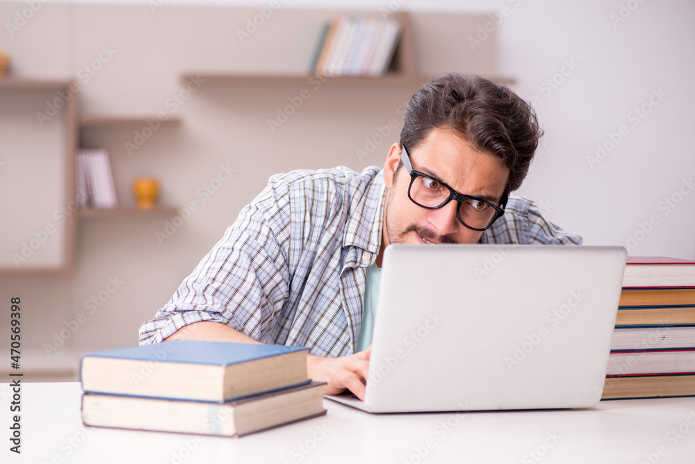 Young male student preparing for exams at home Young male student preparing for exams at home