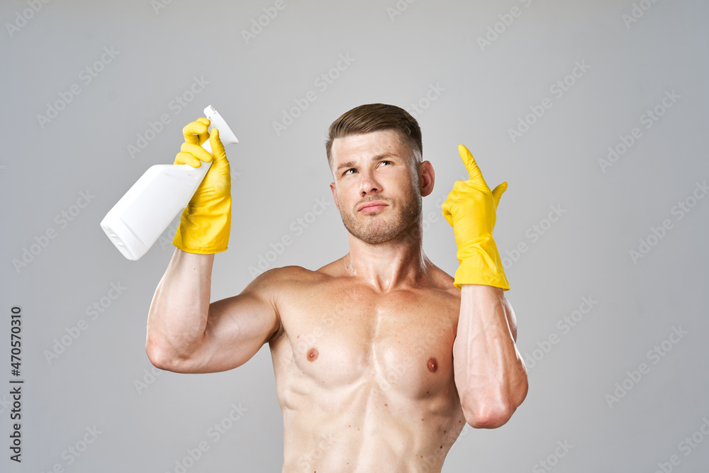 pumped up man posing with detergent in rubber gloves pumped up man posing with detergent in rubber gloves