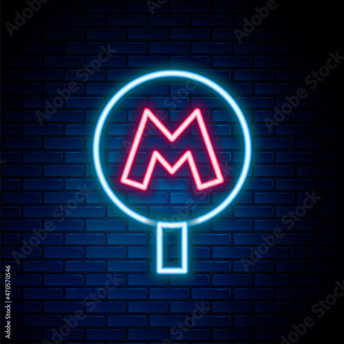 Glowing neon line Metro or Underground or Subway icon isolated on brick wall background. Colorful outline concept. Vector