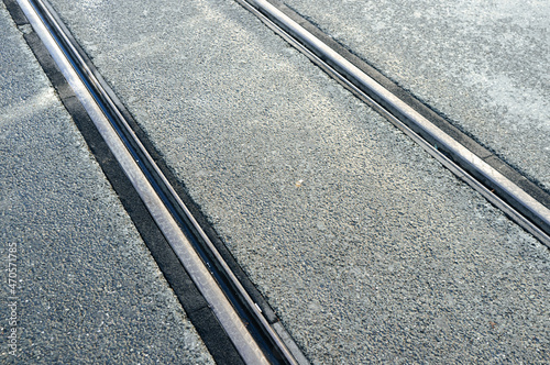 Running metal rails of modern tramway on pavement
