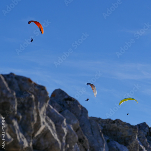 Paraglider flying over mountains in summer day in front of the mountain, High quality photo