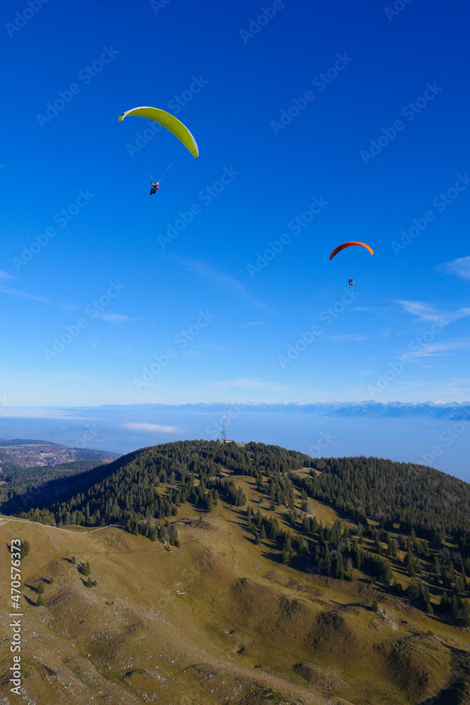 Paraglider flying over mountains in summer day in front of the mountain, High quality photo Paraglider flying over mountains in summer day in front of the mountain, High quality photo
