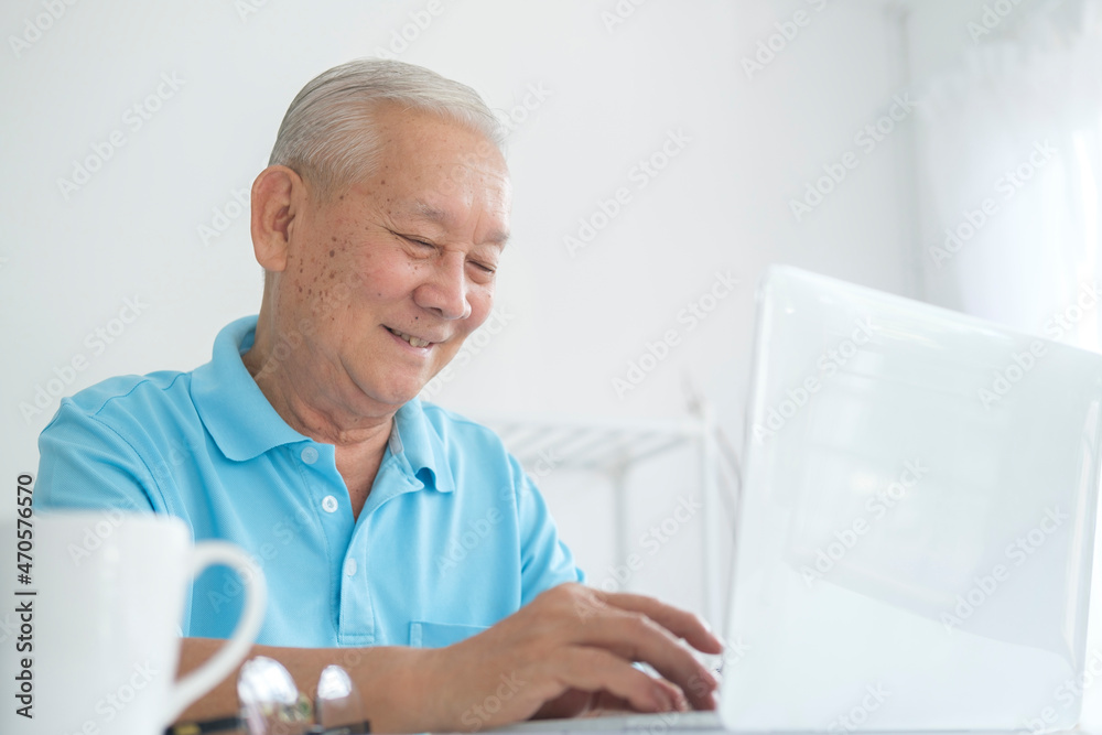 Senior man using laptop at home.. Senior man using laptop at home..