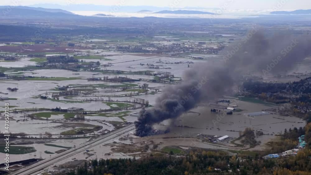 Aerial View Of Catastrophic Flooding And Black Smoke Rising From Burning RV Vehicles In Abbotsford, BC, Canada.