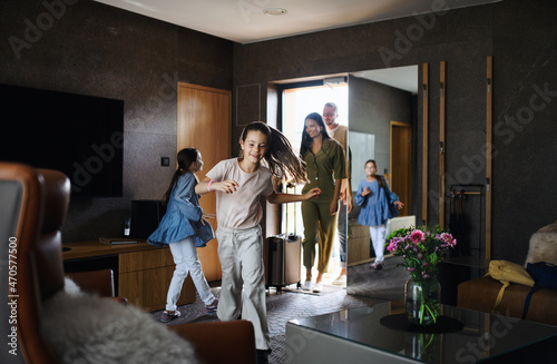 Tableau sur toile Happy young family with two children enetring room at luxury hotel, summer holiday