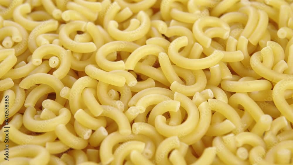 Uncooked Italian Gobbetti Pasta. Macro. Slow rotation. Dry wheat macaroni. Mediterranean cuisine Uncooked Italian Gobbetti Pasta. Macro. Slow rotation. Dry wheat macaroni. Mediterranean cuisine