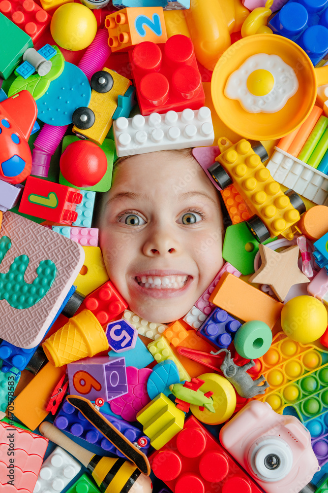 Child's face in the plenty of toys