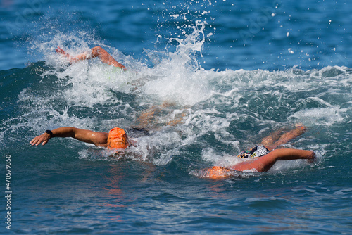 Group swimmers swimming crawl in blue sea, training for triathlon © pavel1964