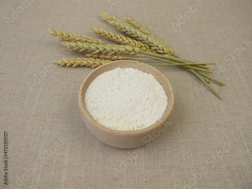 Fine wheat flour in a wooden bowl for the production of baked goods and pasta