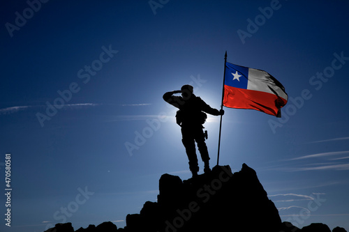 Silhouette of an unrecognizable soldier with the Chilean flag photo