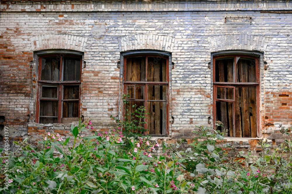 The windows of a dilapidated merchant building of the 19th century in the city of Kamen-na-Ob, Russia
