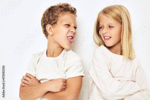 Obraz na płótnie Two preschool children boy and girl quarrel resentment isolated background