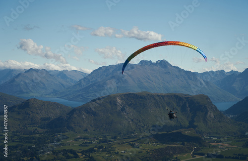paraglider over the mountains and blue sky
