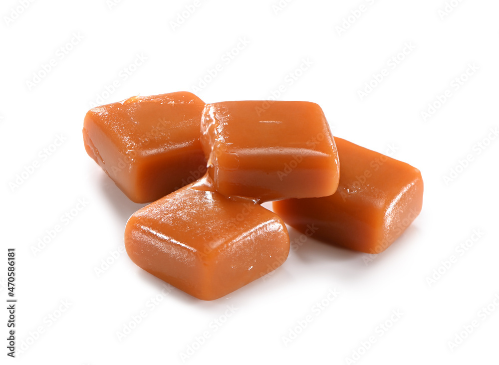lightly melted pieces of four toffee caramel candies close-up isolated on white background with shadow lightly melted pieces of four toffee caramel candies close-up isolated on white background with shadow