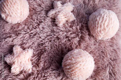 Christmas background with pink fur balls on pink fur background. Winter holidays background. Winter mood © vetre