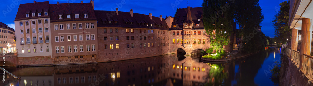 Nuremberg. Old stone buildings above the canal at sunset.