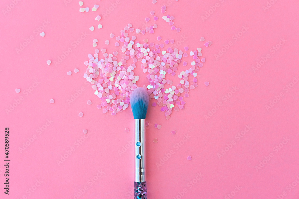 Makeup brush and shiny pink sequins on a pink background. Festive magic makeup concept. Template for design, top view Flat Lay Copy space. Makeup brush and shiny pink sequins on a pink background. Festive magic makeup concept. Template for design, top view Flat Lay Copy space.