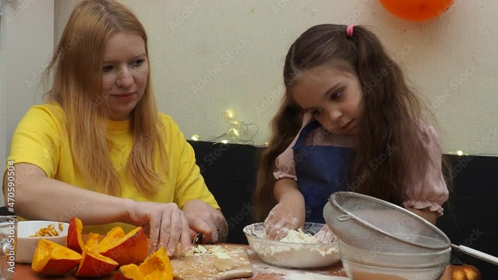 Mam And Daughter Are Making Dough pie For Thanksgiving Pie. put the dough in a mold for a thanksgiving pumpkin pie. Process of making Pumpkin pie for Thanksgiving Day. Seasonal traditional autumn fest