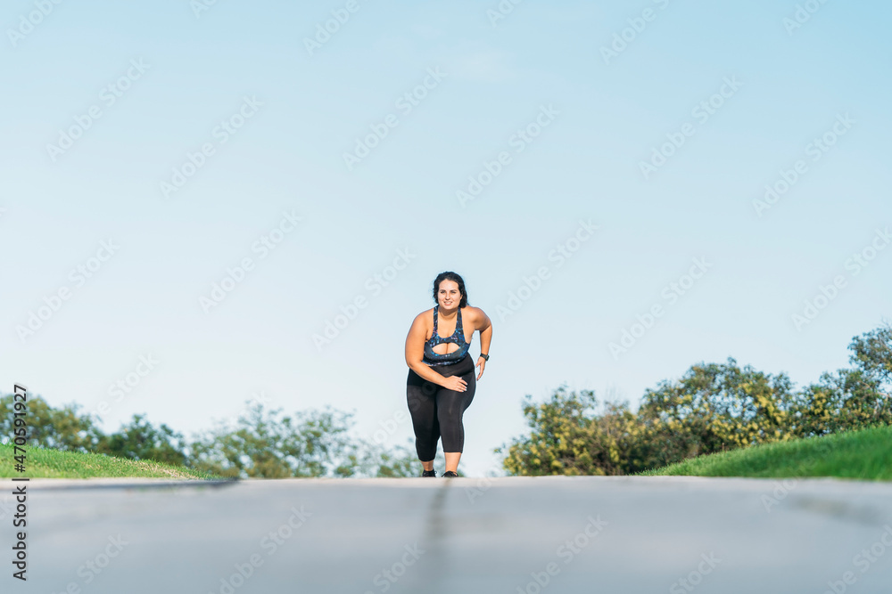 Young female athlete running on road Young female athlete running on road